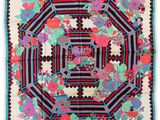 a multicolored floral print scarf with a black and red border