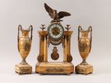 three vases and a clock with an eagle on top