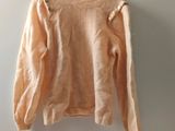 an image of a sweater hanging on a hanger