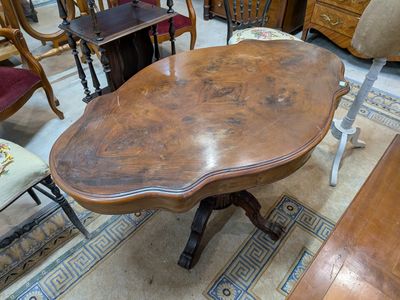 a table that has a wooden top on it in a room