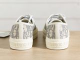someone is wearing a pair of sneakers on a wooden table