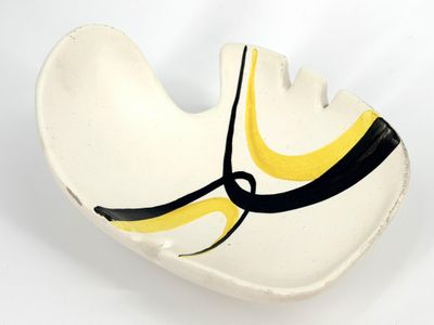 a white bowl with a yellow and black design on it