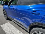 a blue car parked on the side of the road