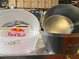two pans sitting on top of a table next to each other