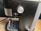 a coffee maker that is sitting on a wooden table