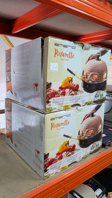 two boxes of pizza sitting on a shelf in a store