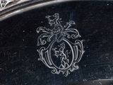 a silver plate with a silver emblem on it