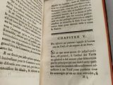 an open book on a table that has a picture of a cat on it