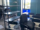 tables and chairs in a room with a view of a window