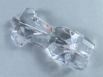 a clear glass object on a table with a white background