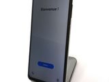 a close up of a cell phone sitting on top of a stand