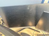 two computer monitors sitting on top of a desk next to each other