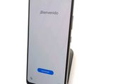 a close up of a cell phone on a stand on a white surface