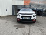 a white citrole parked in front of a building