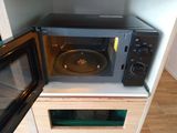 a microwave that is sitting on top of a cabinet