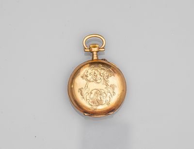 an antique gold pocket watch with a chain on a white surface