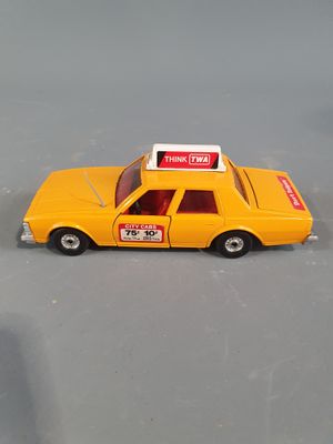 a yellow toy car with a sign on top of it