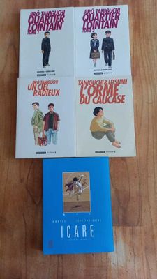 four books on a table with a wooden table top