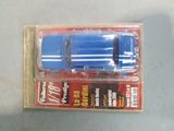 a blue toy truck in a package on a table