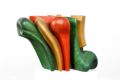 a wooden sculpture of different colors and shapes on a white surface