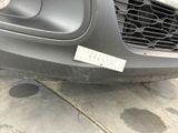 a close up of a car ' s front bumper with a sticker on it