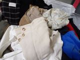 a pile of clothes that is sitting in a suitcase