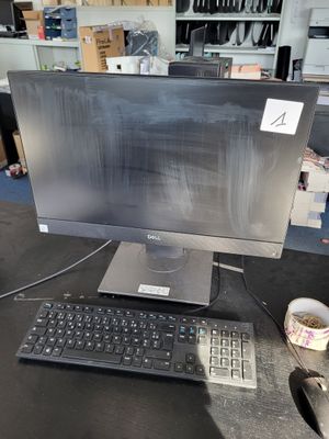 an image of a computer monitor and keyboard on a desk