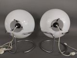 pair of chrome and glass table lamps with white globe shades