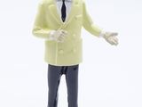 a figurine of a man in a yellow jacket and tie