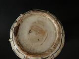 a close up of a vase on a black surface