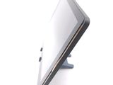 a tablet computer sitting on a stand on a white surface