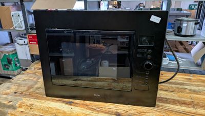 a microwave that is sitting on a table in a room