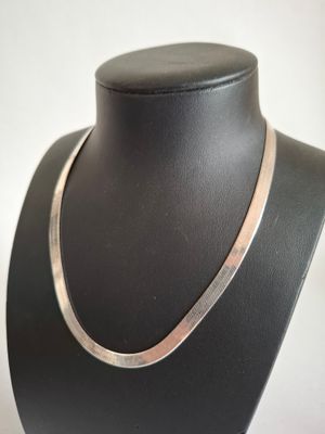 a close up of a necklace on a mannequin neck