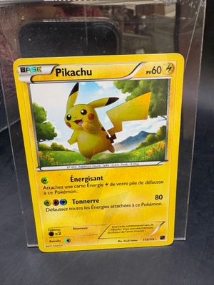 the pokemon card is in a clear box on the table