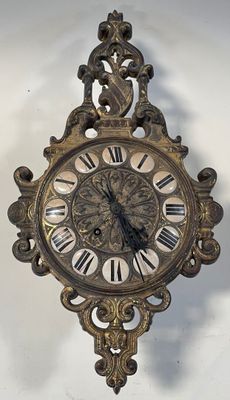a clock on the wall with roman numerals on it