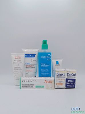 un assortiment de produits de soins de la peau posés sur une surface blanche