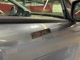 a car with a sticker on the side of it ' s door