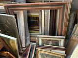 a pile of old picture frames and pictures in a pile