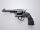 a close up of a revolver on a table with a tag on it