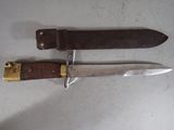 two knives are sitting side by side on a white surface