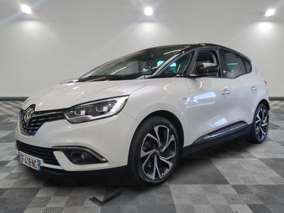 a white car parked in a room with a checkered floor
