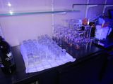 bottles and glasses on a table with a towel on it