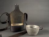 a bottle and a bowl sitting next to each other on a table