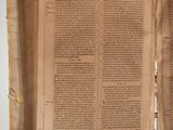 an old book opened to reveal a page of text on a white background
