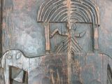 a wooden carving of a horse and a man on a horse