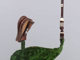 a sculpture of a snail on top of a green leaf