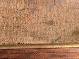 a close up of a wooden table with a clock on top of it