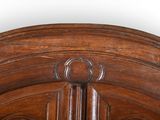 a close up of a wooden bed with a wooden headboard