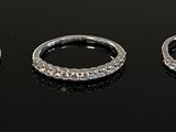 three silver rings sitting on top of a table next to each other