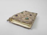 a close up of a small book with beads on it